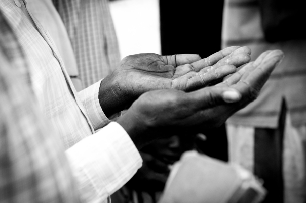 The hands of a Sudanese man in prayer.