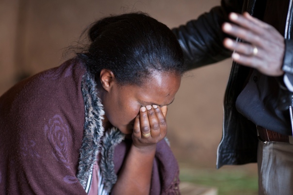 A woman being prayed for in the medical clinic.
